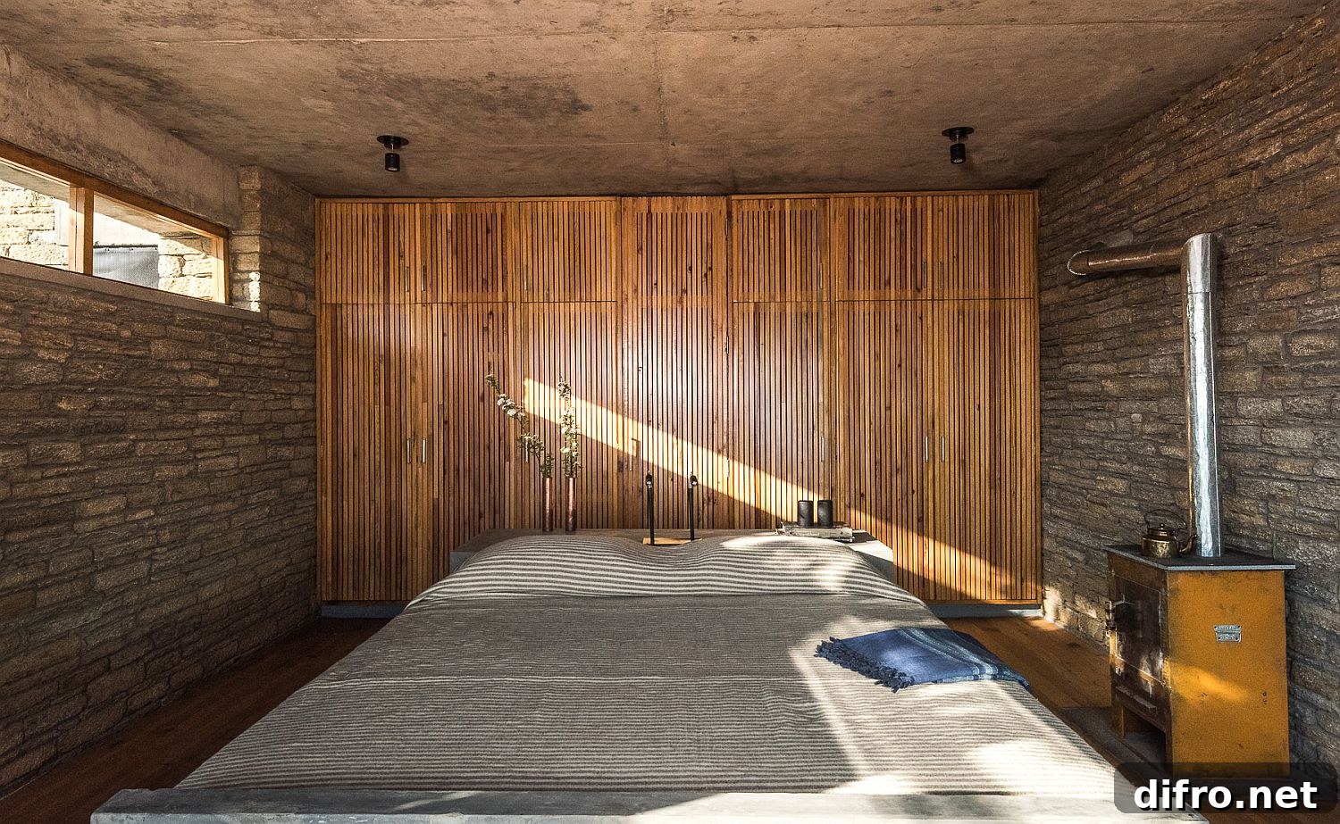 Bedroom interior featuring fly ash bricks and bamboo finishes