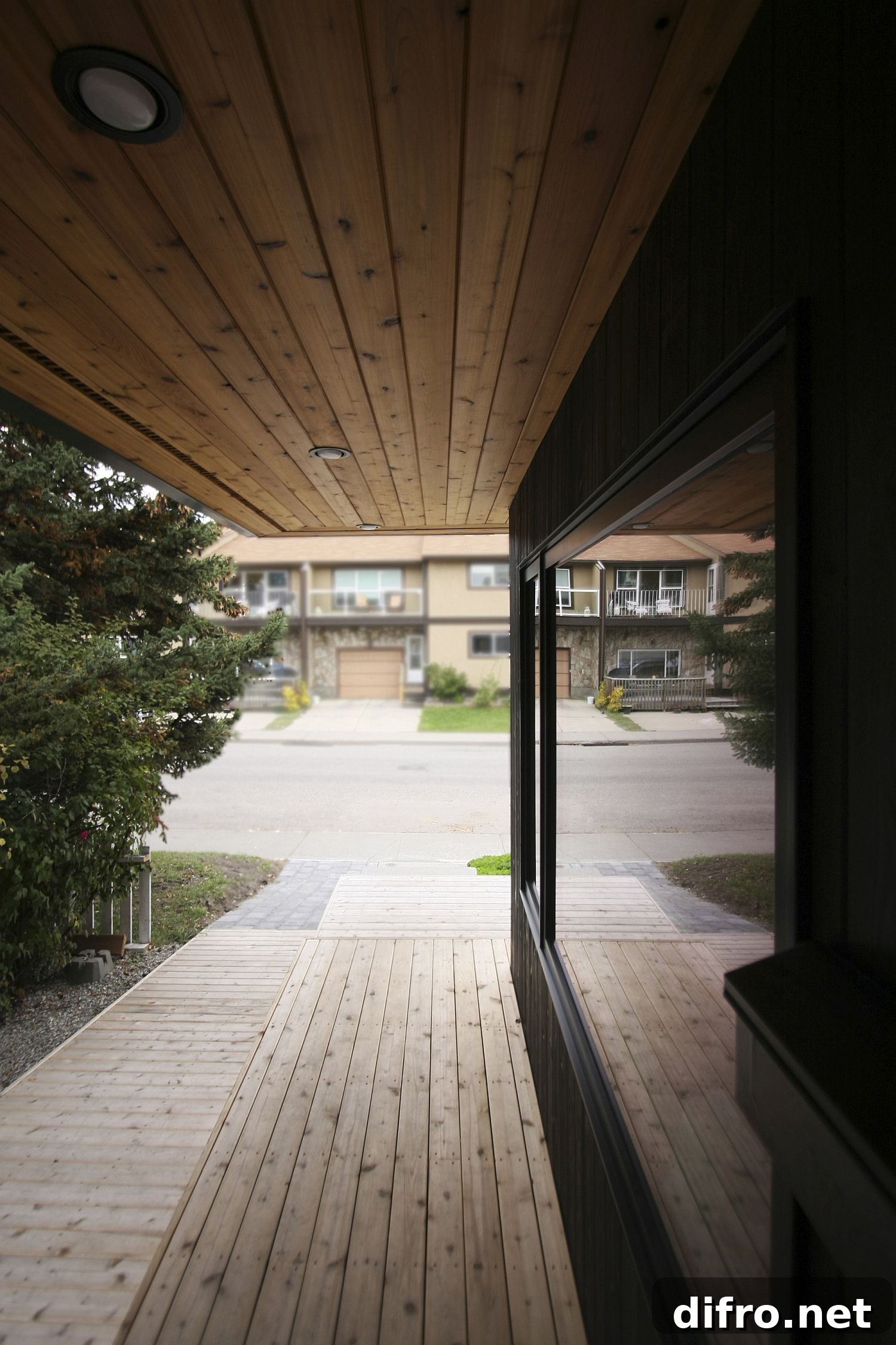 Sheltered wooden walkway around the Hillhurst Laneway House