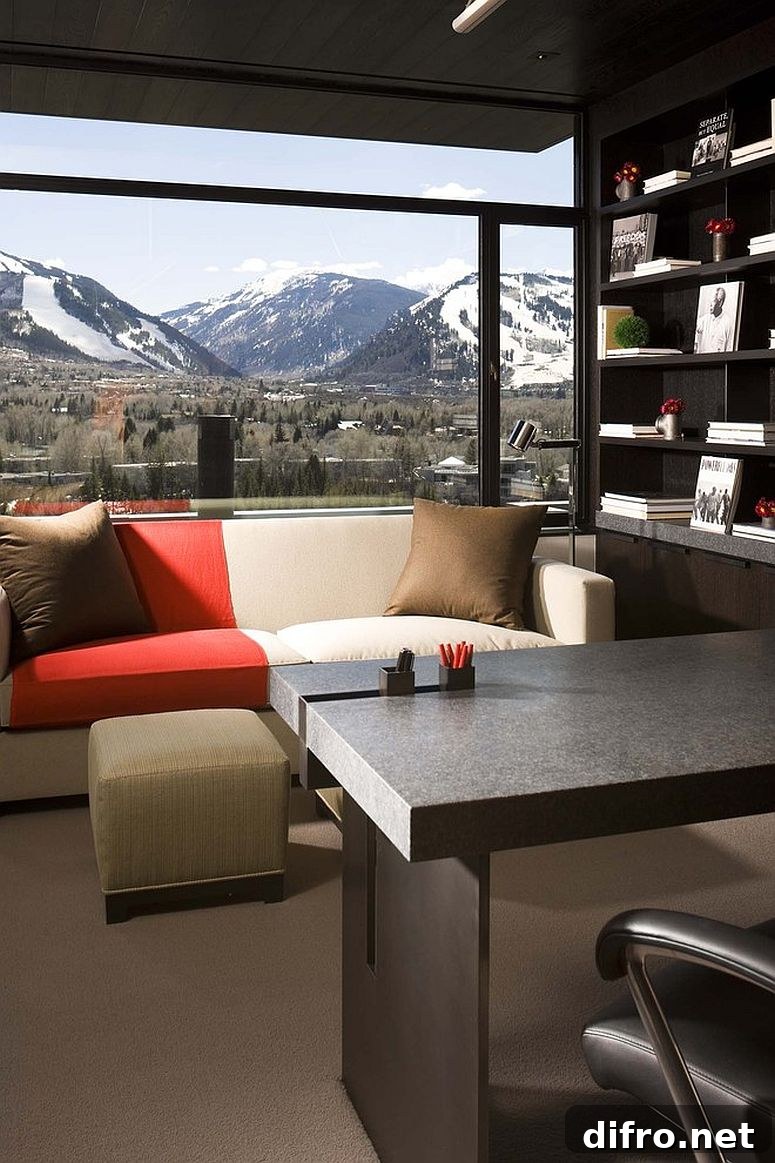 Dark contemporary home office with snow-covered mountain view