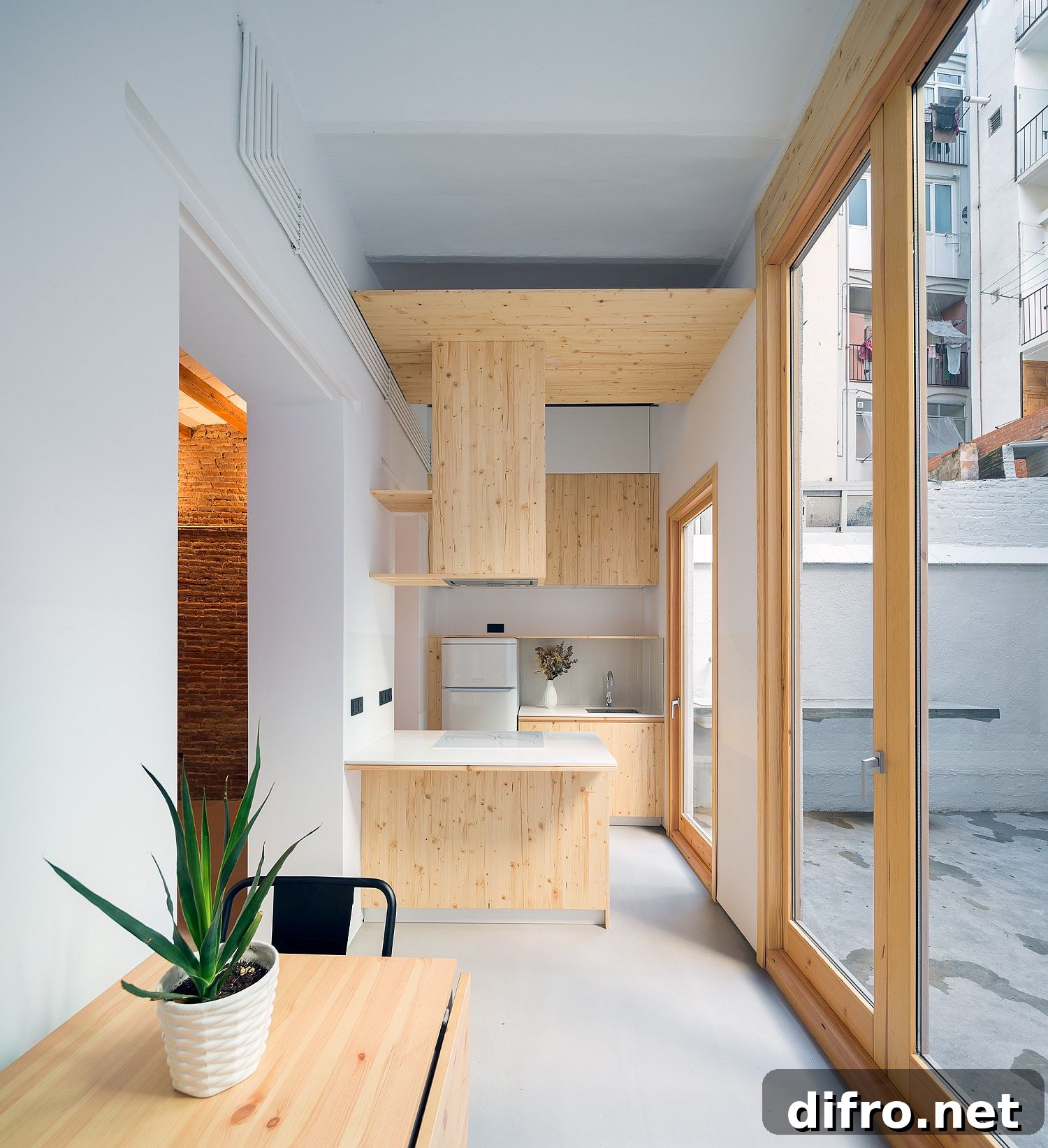 Exquisite and space-savvy tiny kitchen in white and wood