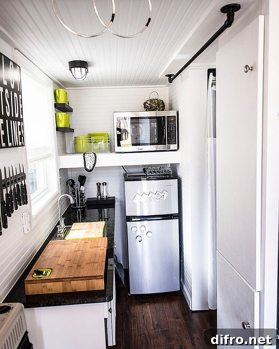 Eclectic kitchen within an ultra-tiny apartment in white with dark countertops
