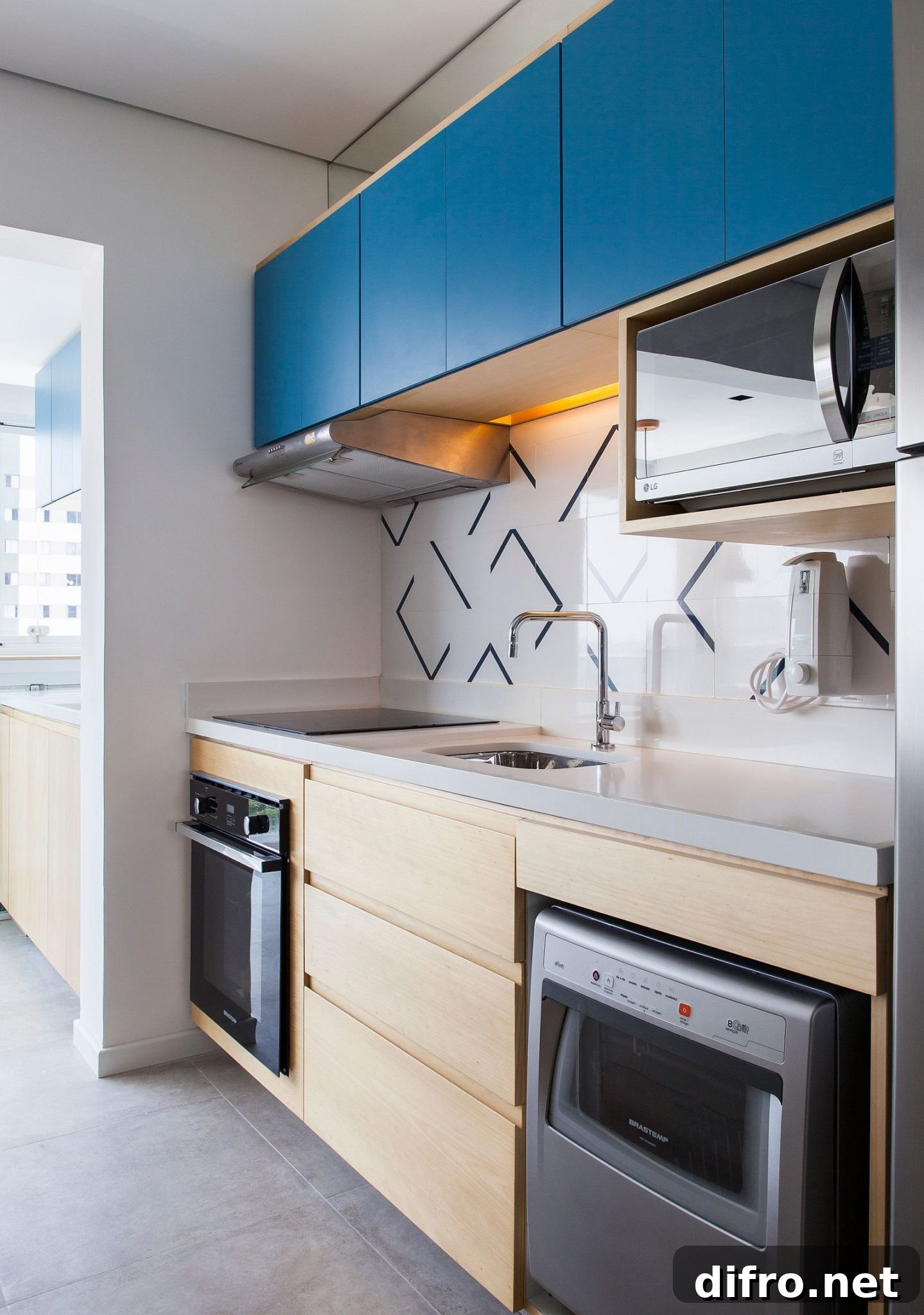 Small single wall kitchen with bright blue cabinets atop!