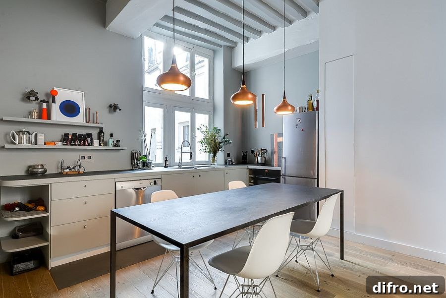 Tiny corner L-shaped kitchen inside the chic Paris apartment