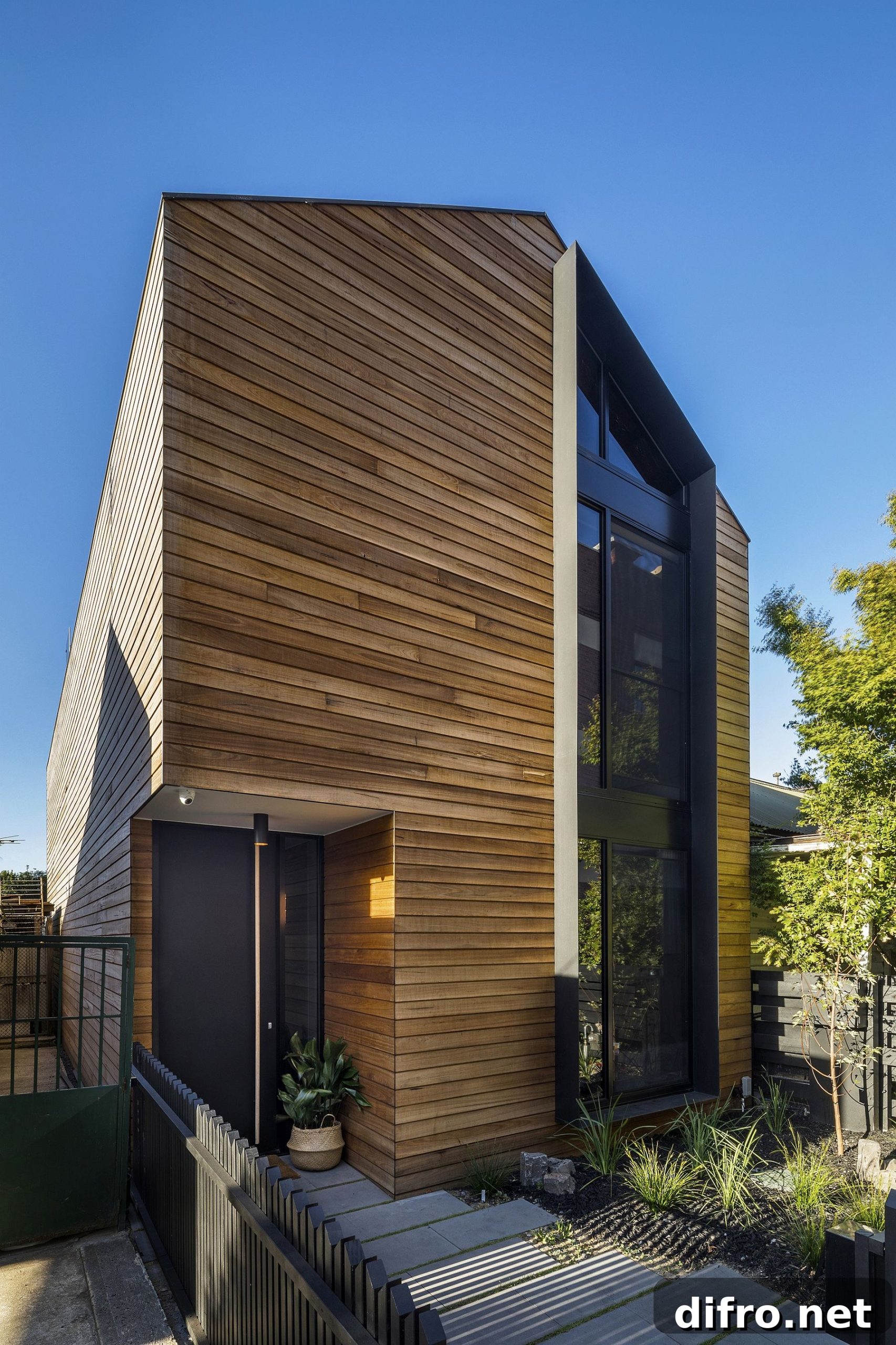 Wooden slats cover the street facade of the T2 Residence
