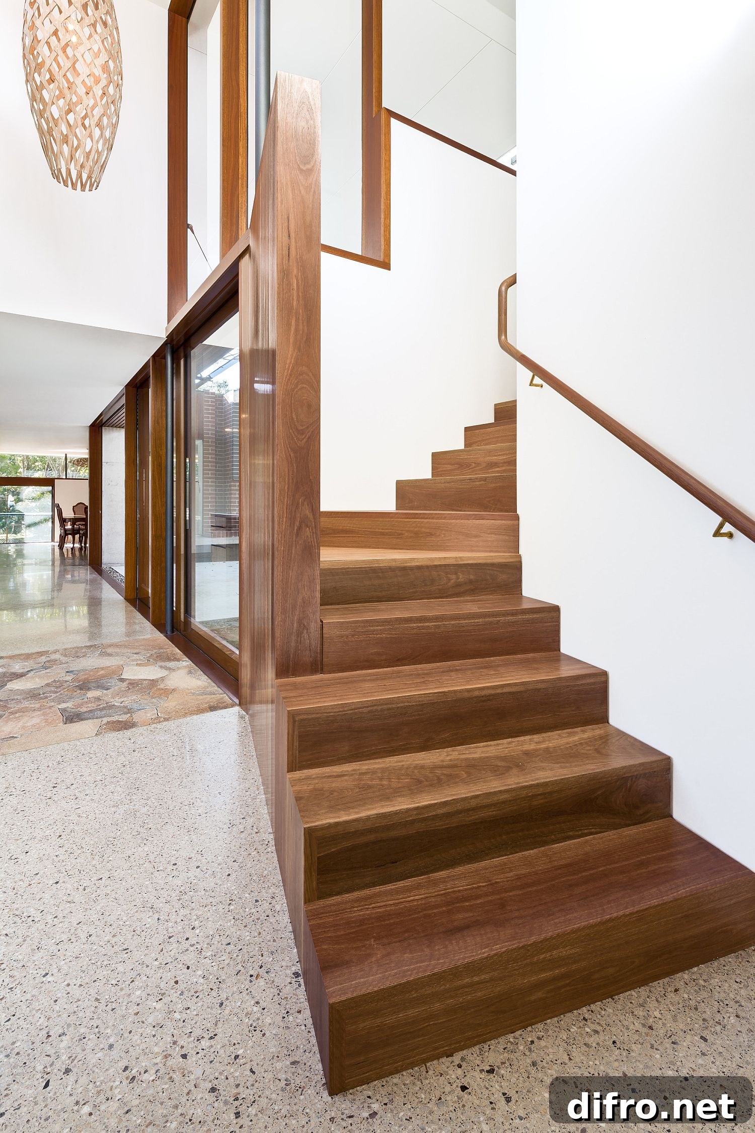 Wooden stairway connects living area with bedrooms