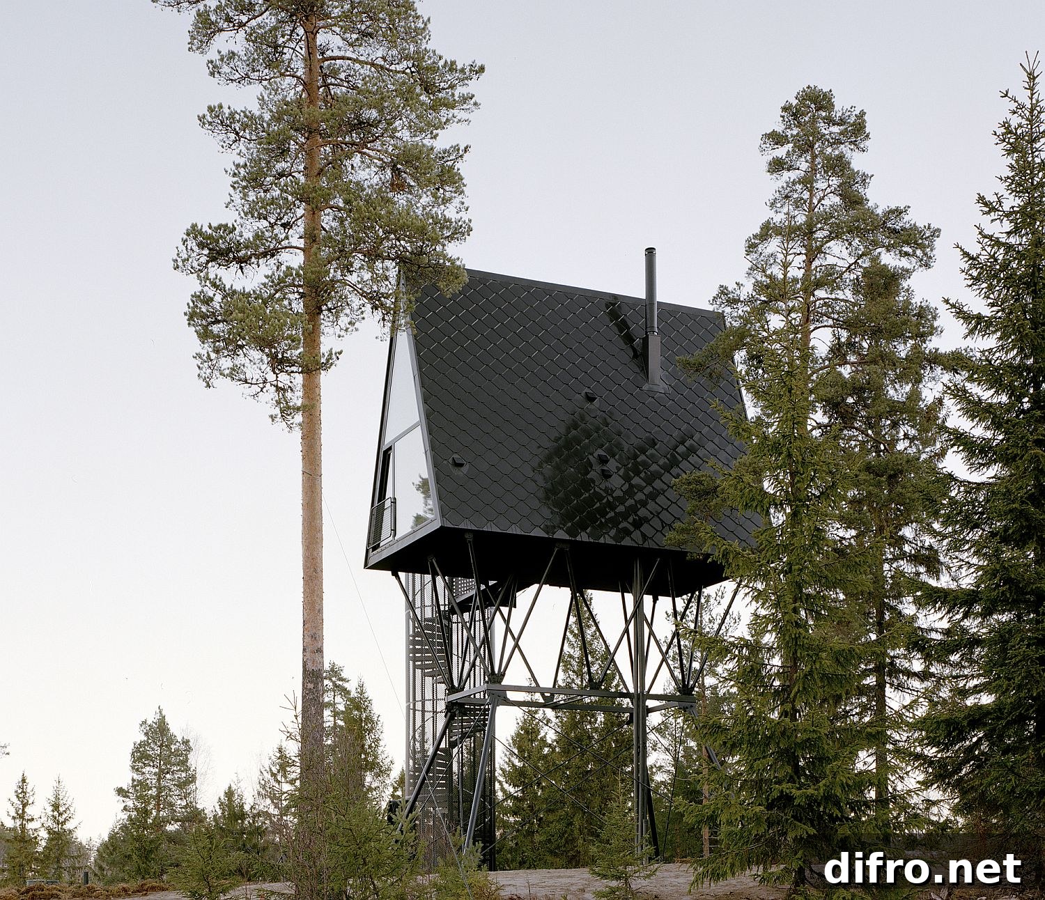 Several modern cabins on steel beams in a Norwegian forest