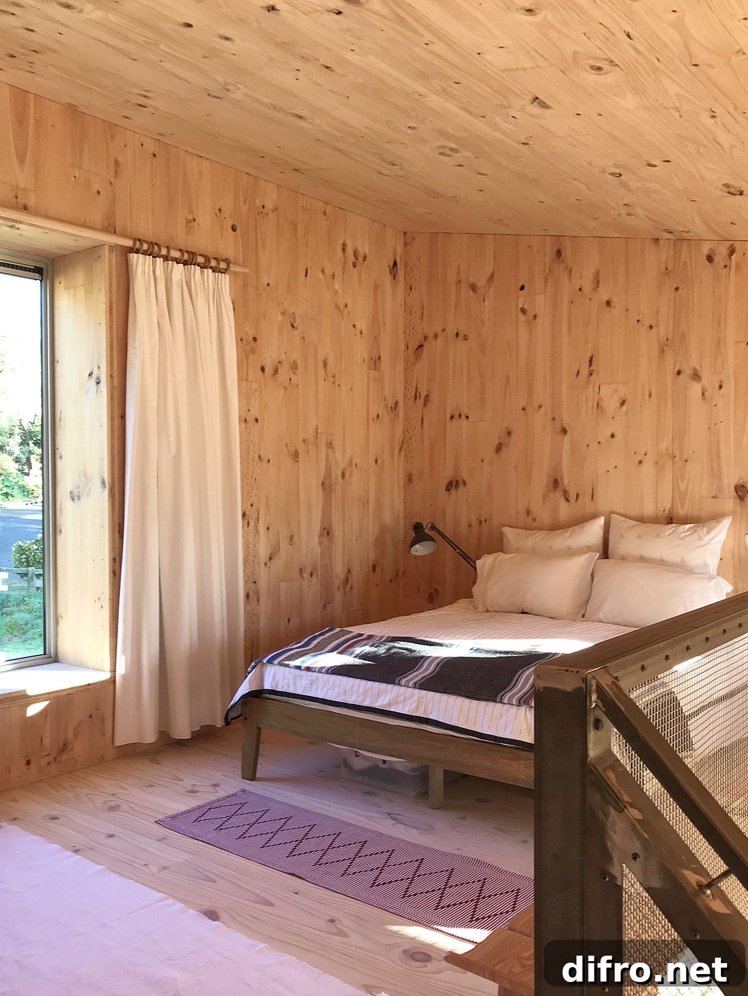 Upper level bedroom of the cabin with cozy modern appeal