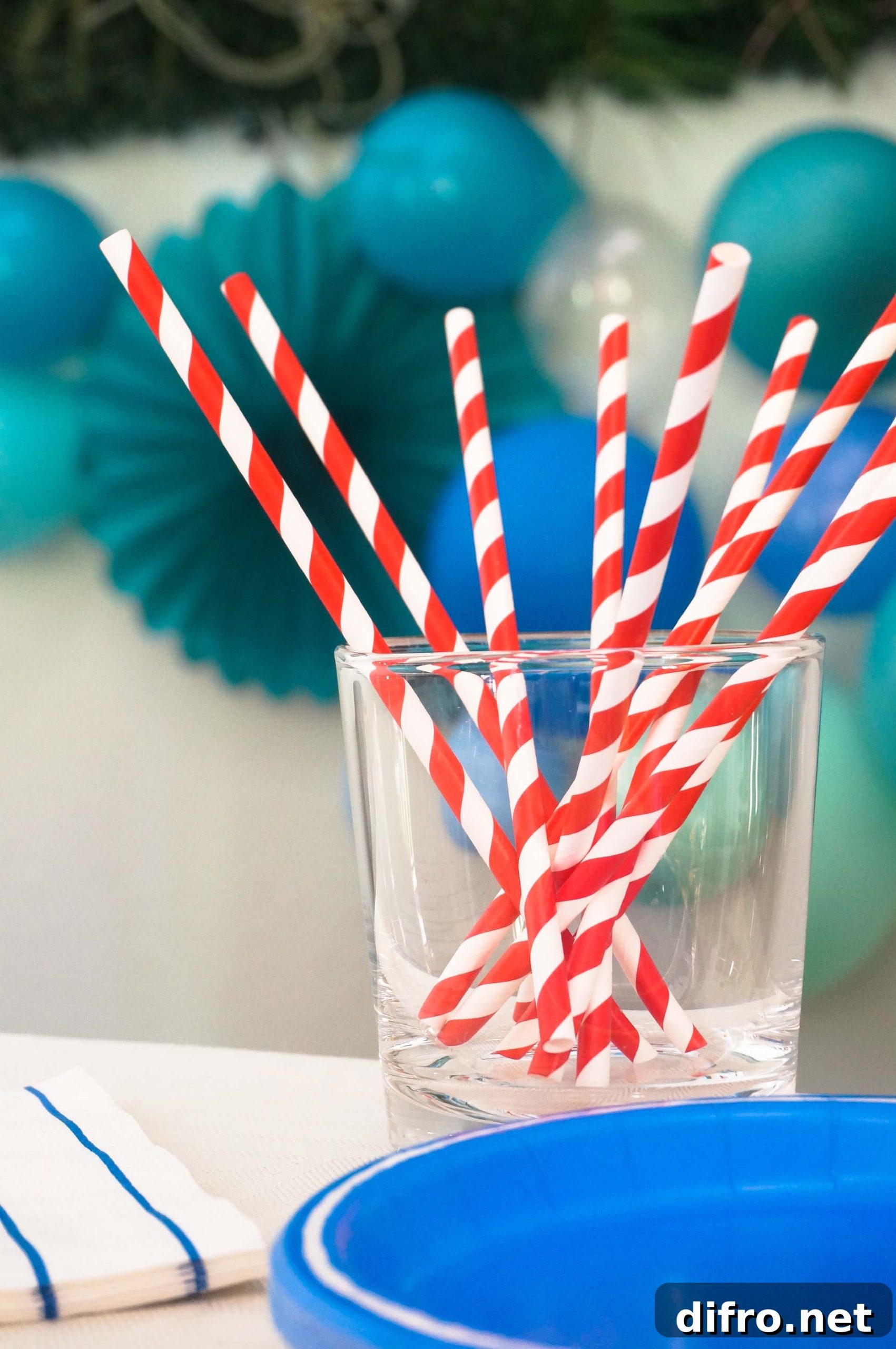 Container of red and white party straws