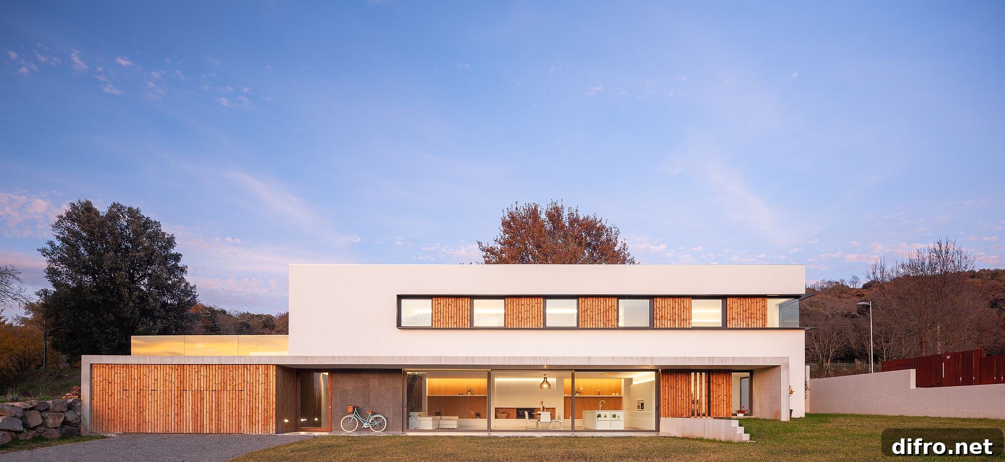 Box-like design of contemporary home in wood and white with lovely lighting