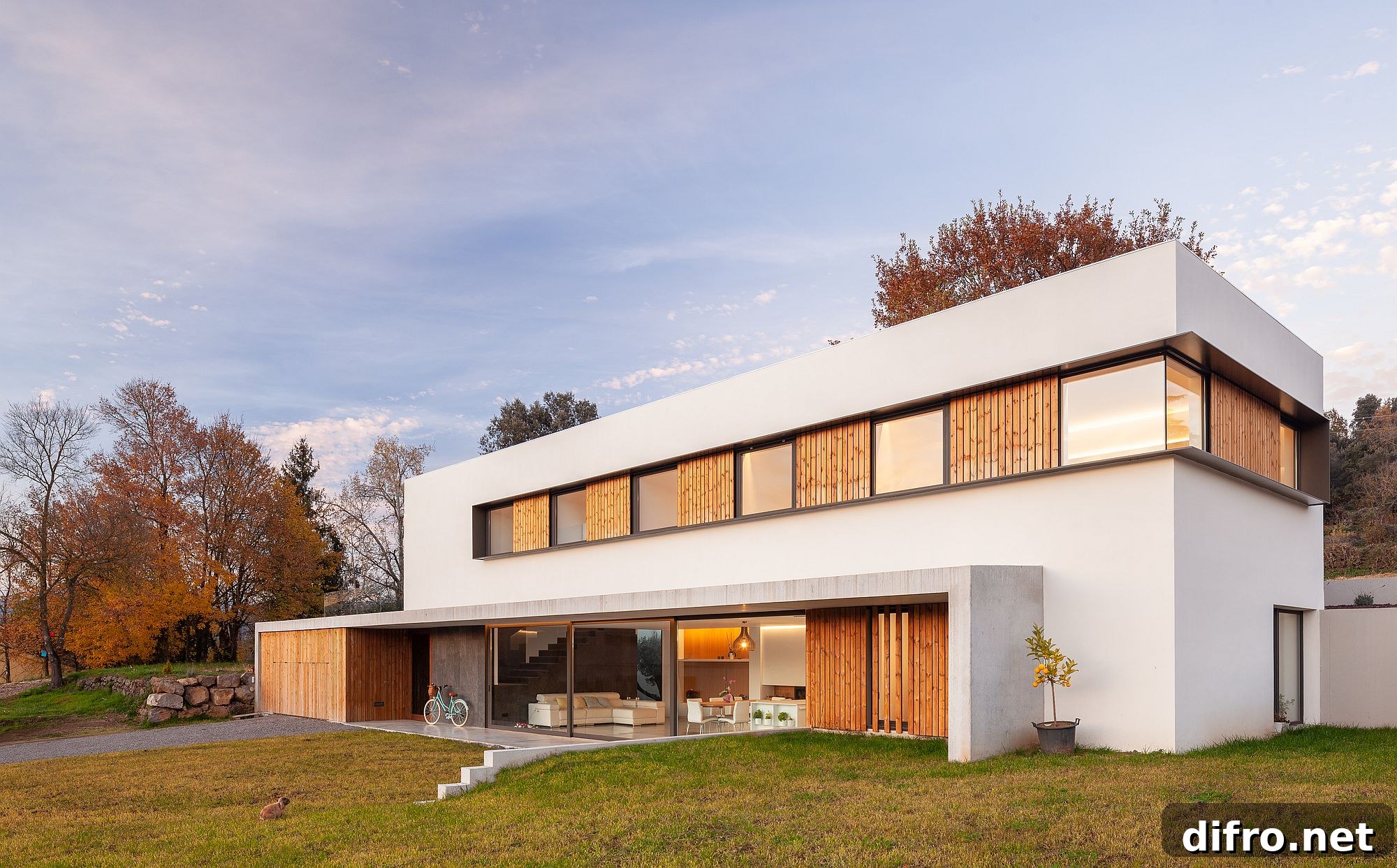 Lovely blend of wood and white shape the exterior of the home in Olot