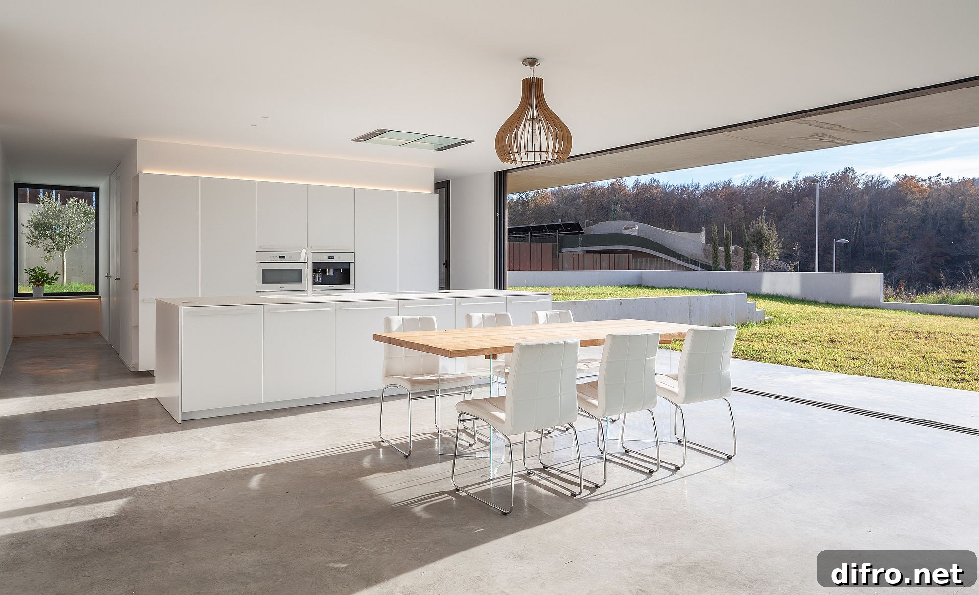White and wood open kitchen design with concrete floor