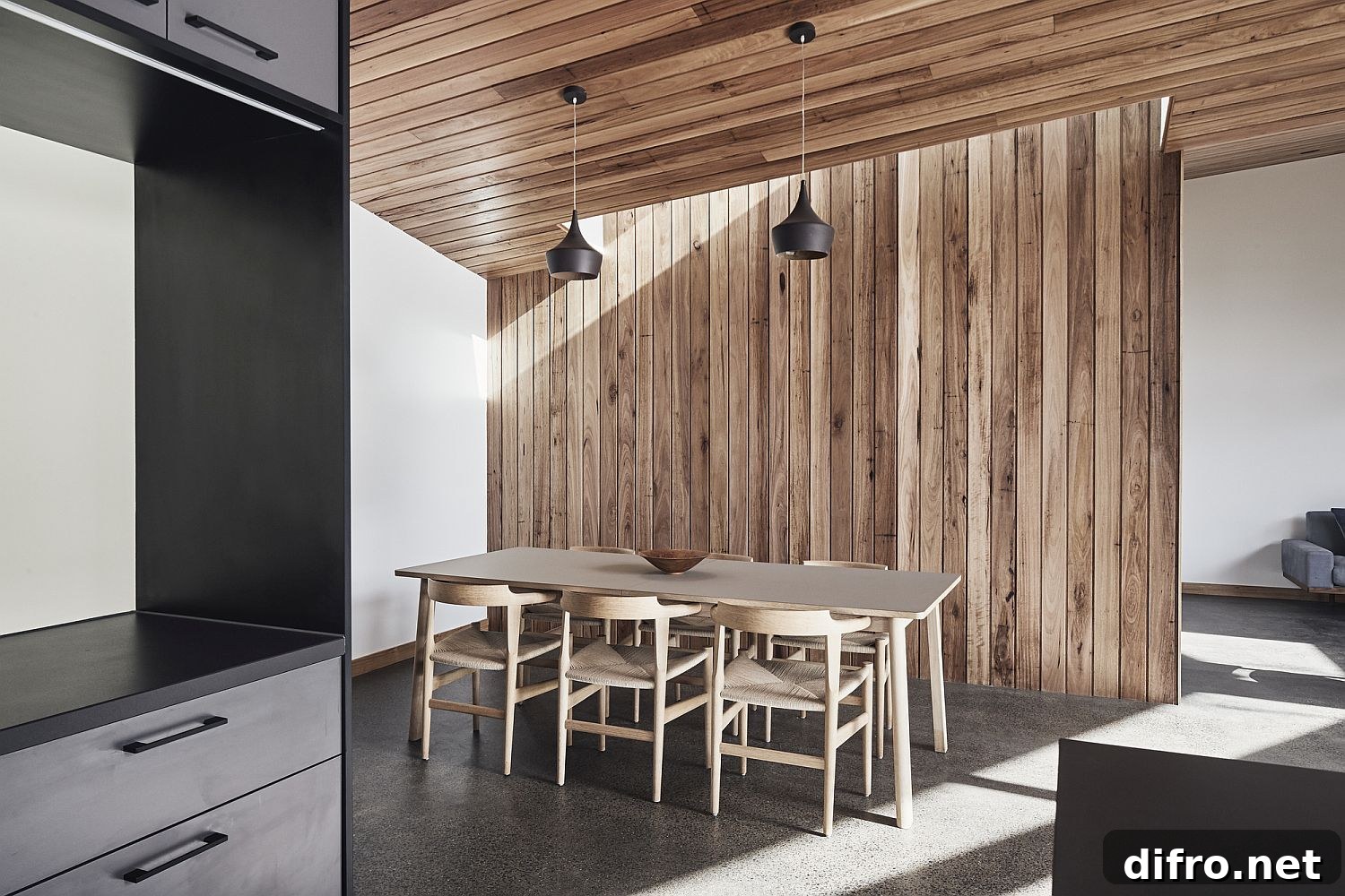 Dining room with wooden walls and contemporary lighting