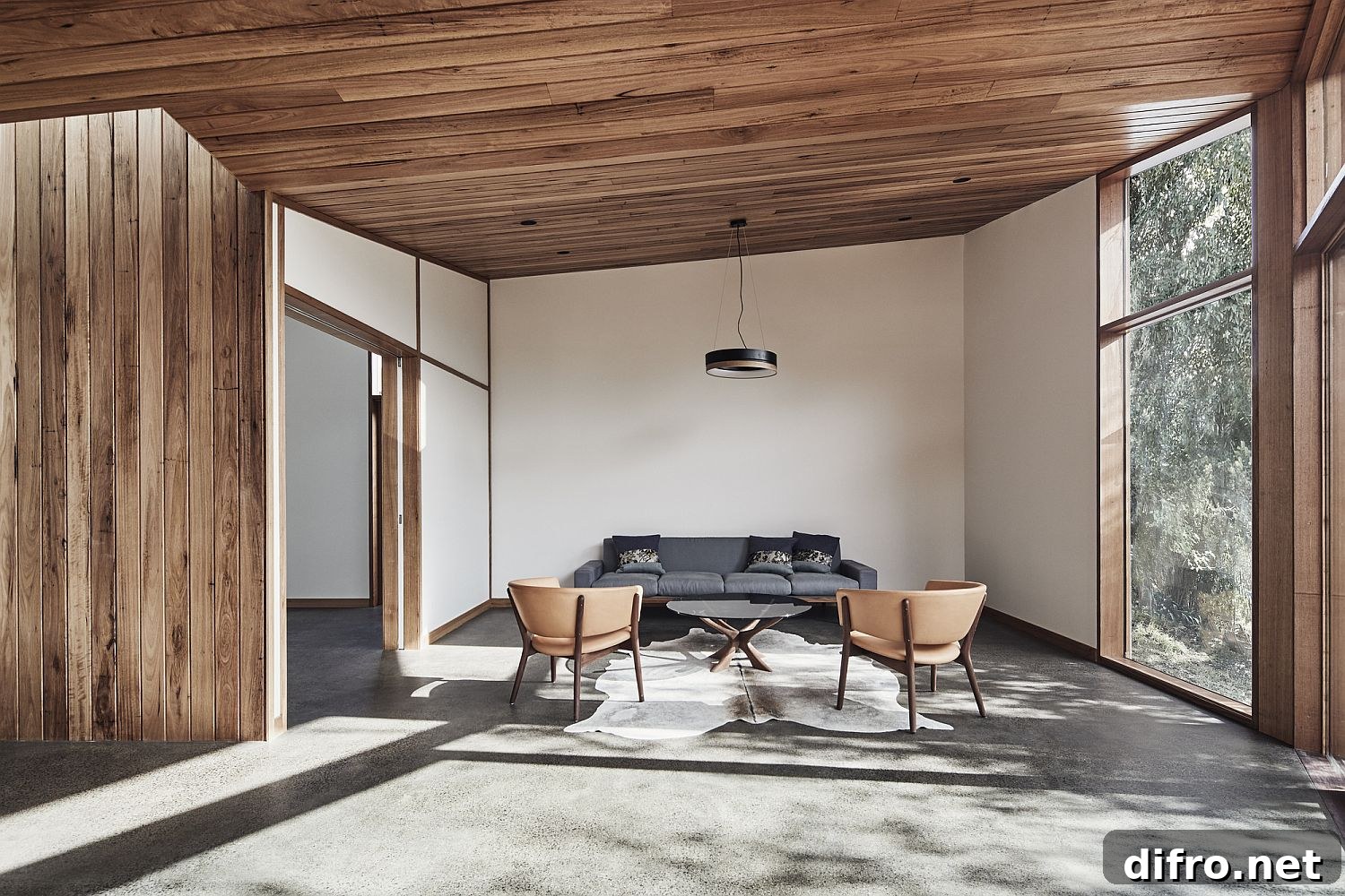 Sitting area with gray sofa and pink chairs
