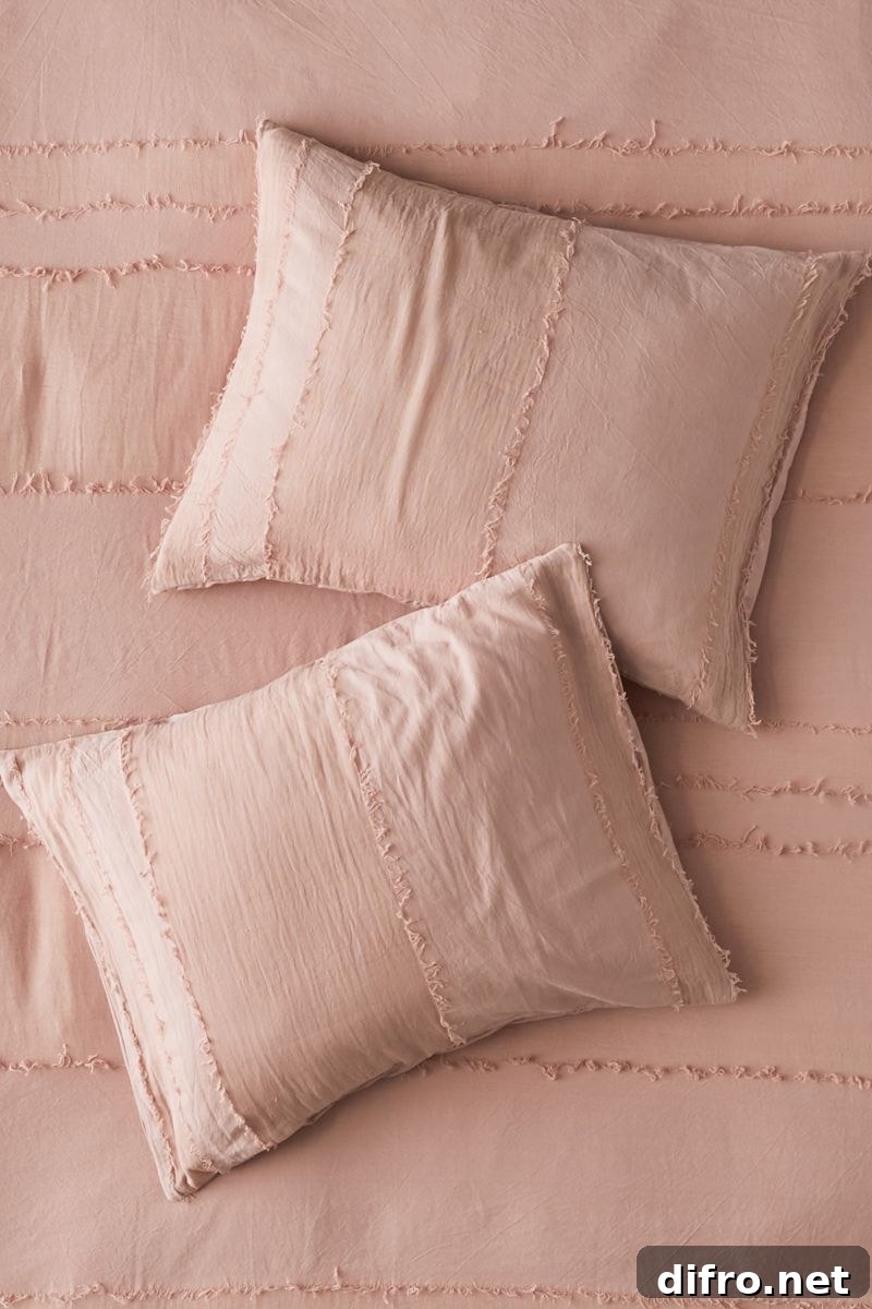 Fringe pillow shams with soft lines and rosy tones