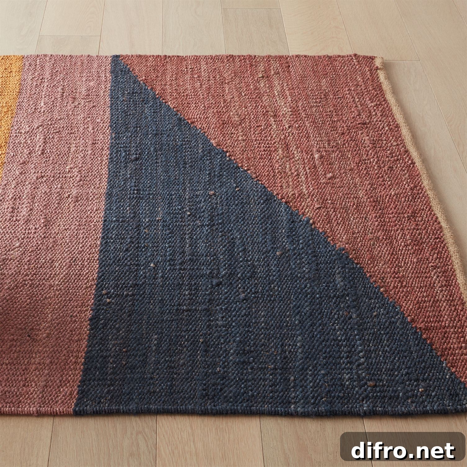 Warm-toned jute rug combining terracotta, mustard, and navy