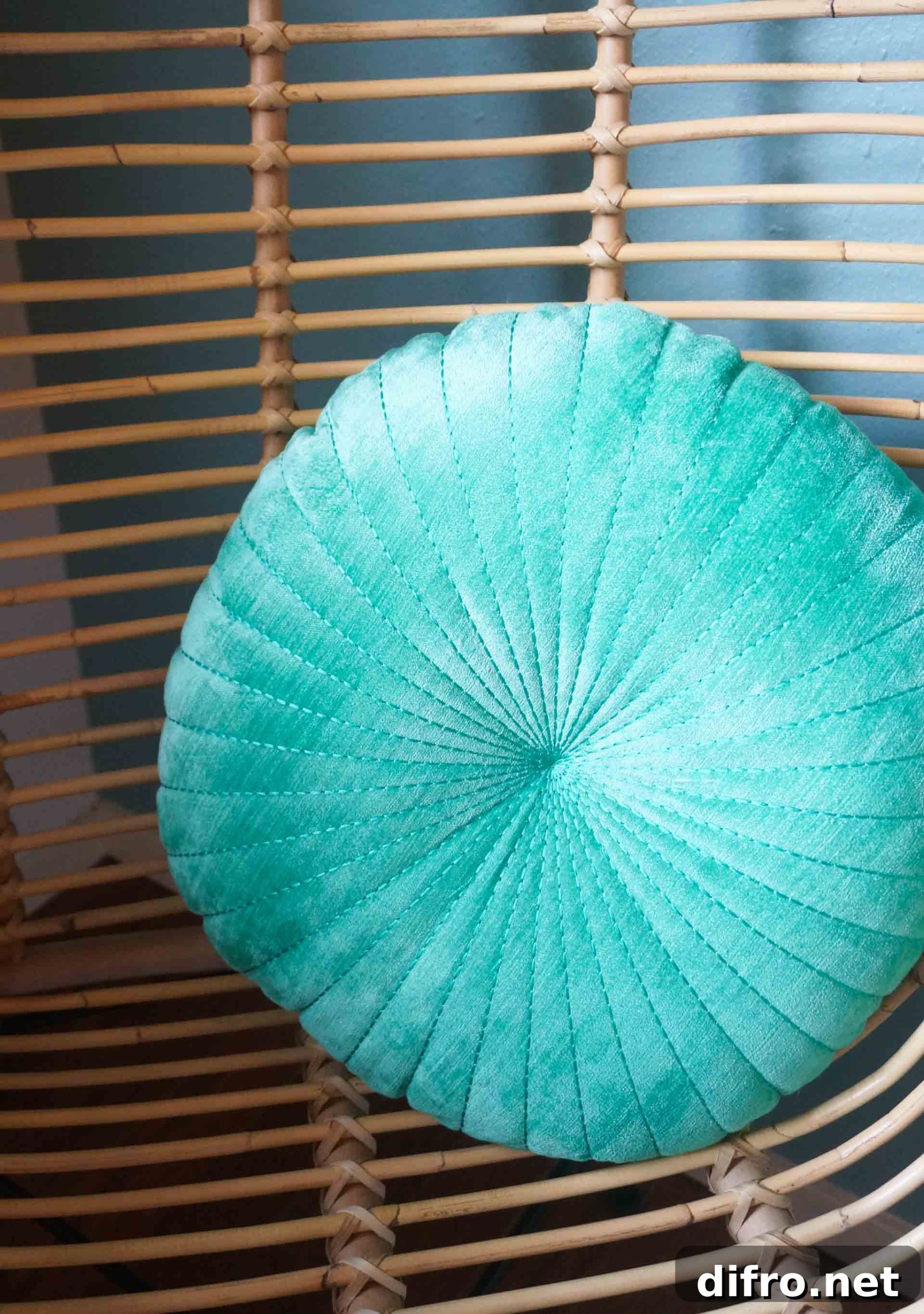 Round shell pillow on a rattan chair