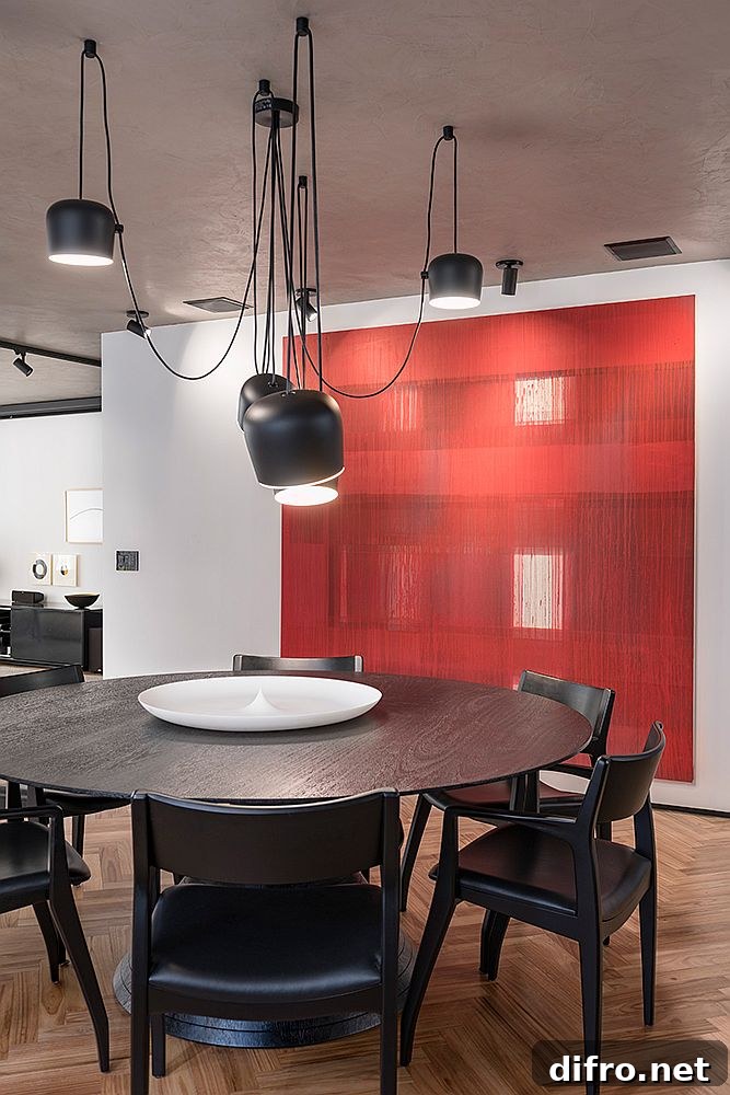 Dining room with a hint of red and stylish contemporary lighting