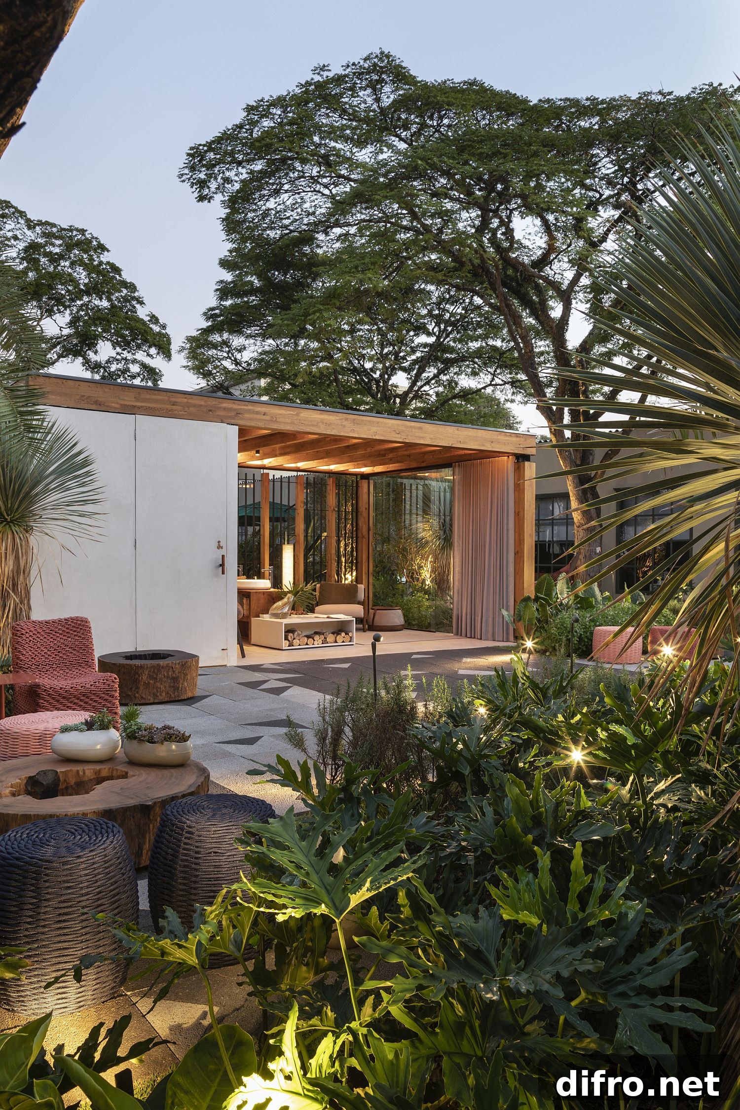 Greenery and lighting create a fabulous setting around the wooden terrace