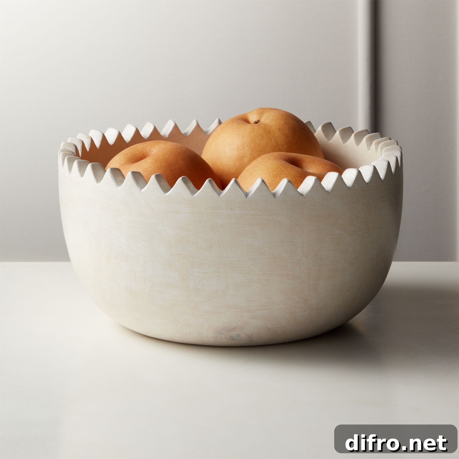 Whitewashed mango wood bowl with zigzag rim used as a centerpiece
