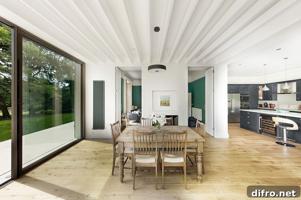 White and wood dining area of the house with sliding glass doors connecting it to the deck outside