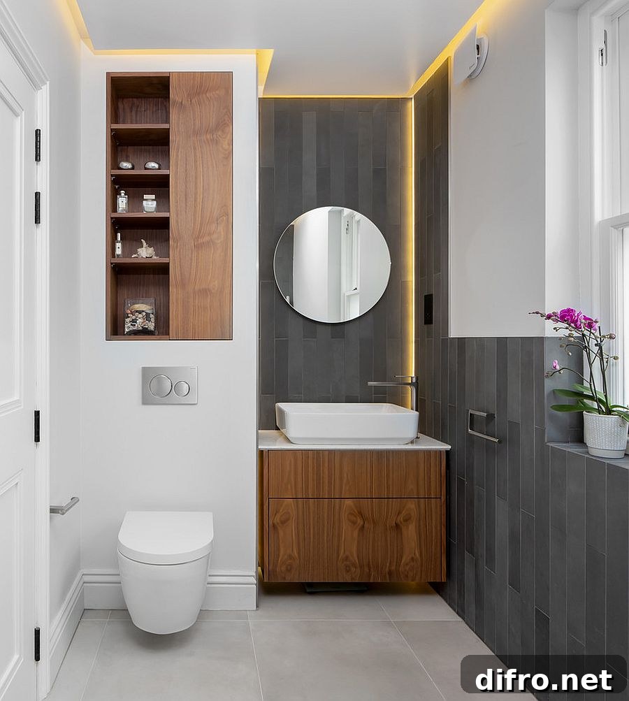 Gray and white Scandinavian powder room with round mirror