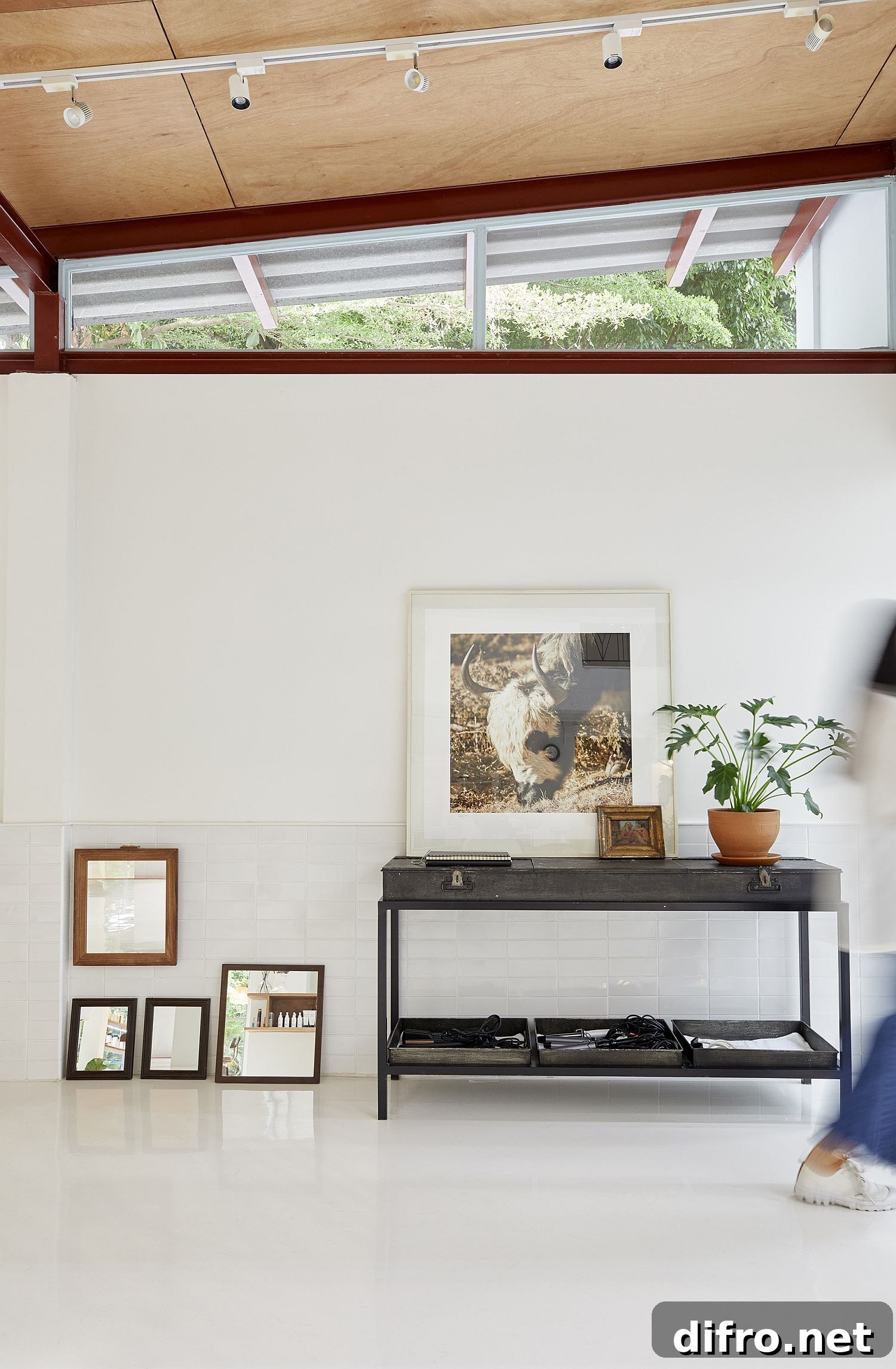 Clerestory windows bring light into the white salon