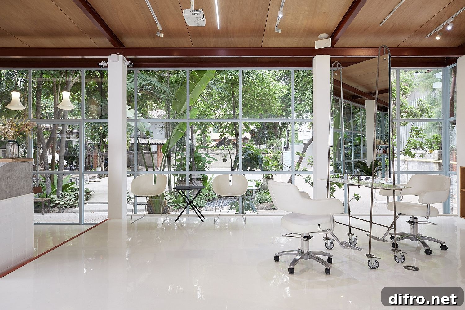 Framed glass walls of the salon connect the interior with the world outside