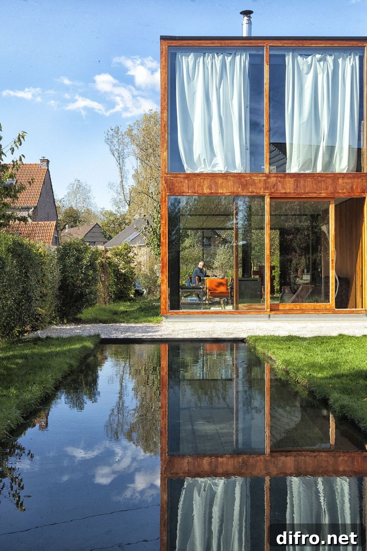 House GePo exterior with glass walls and surrounding greenery