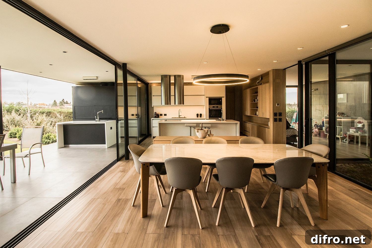 Open plan living area of the house with outdoor kitchen and dining next to it