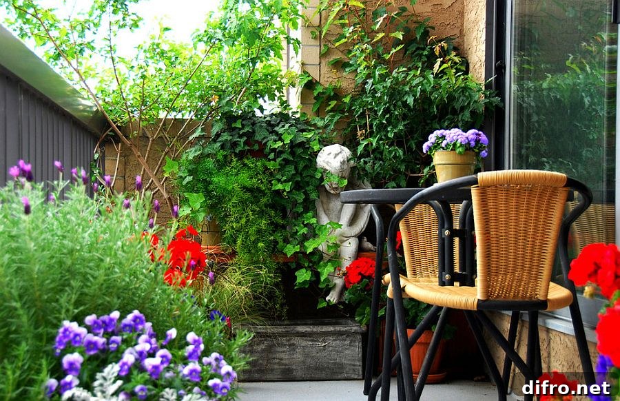 Small balcony filled with plants creating an urban oasis