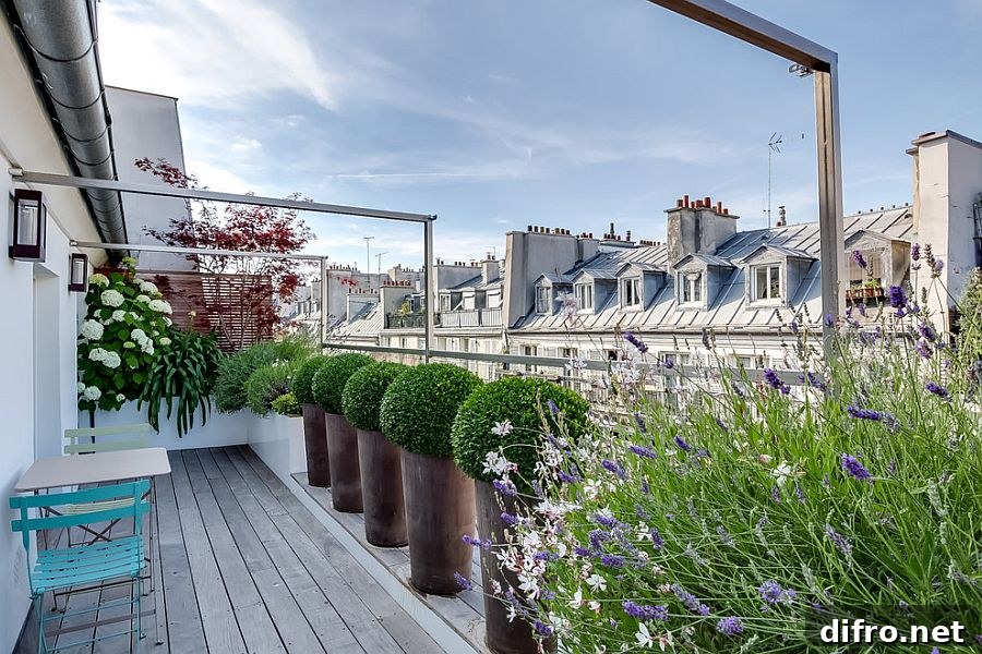 Contemporary balcony with ample greenery and city views