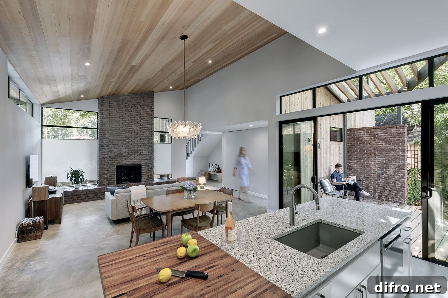 Brick fireplace adds reddish hue to the living room with gable wood ceiling