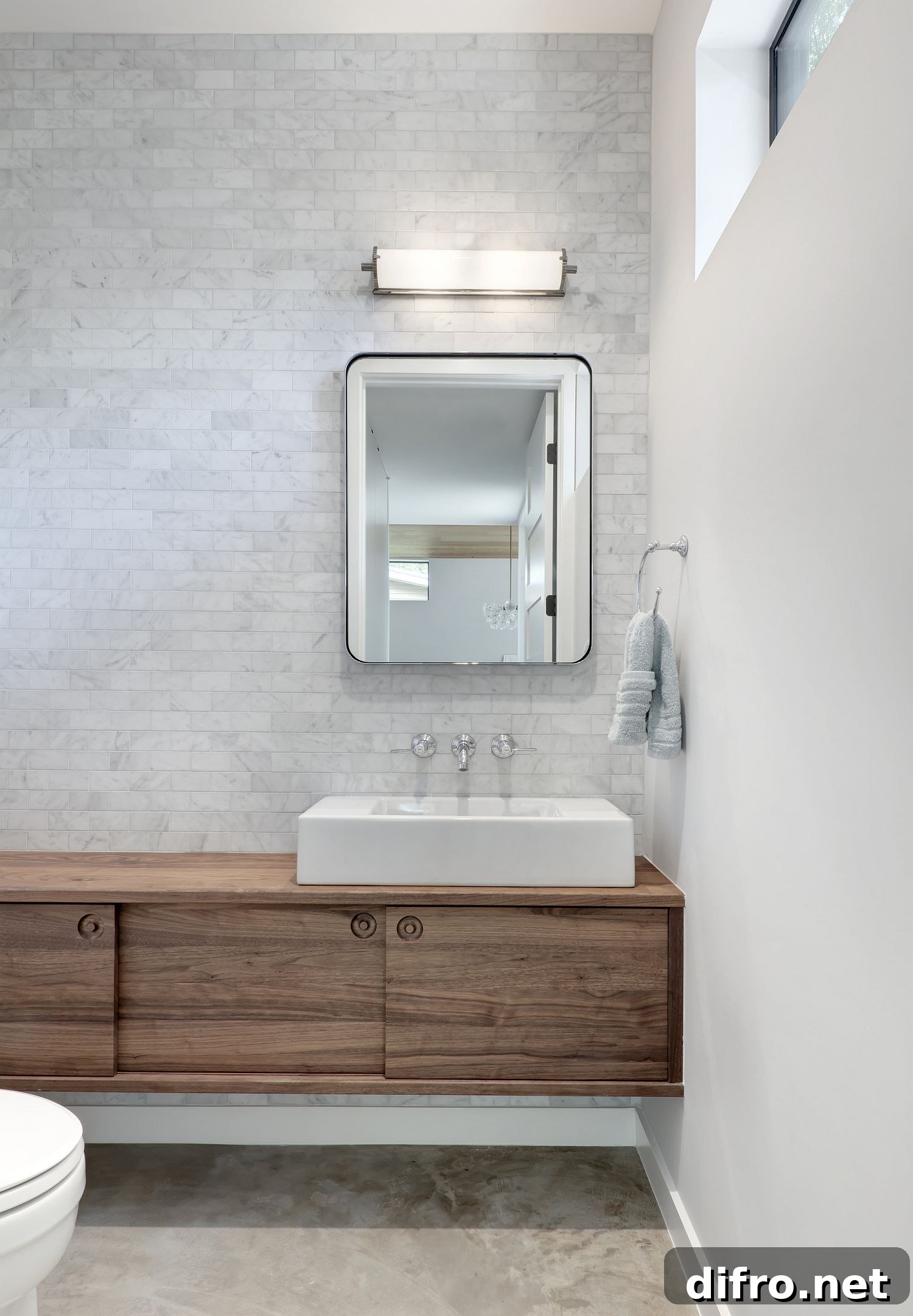 White modern bathroom with contemporary style and a floating wood vanity
