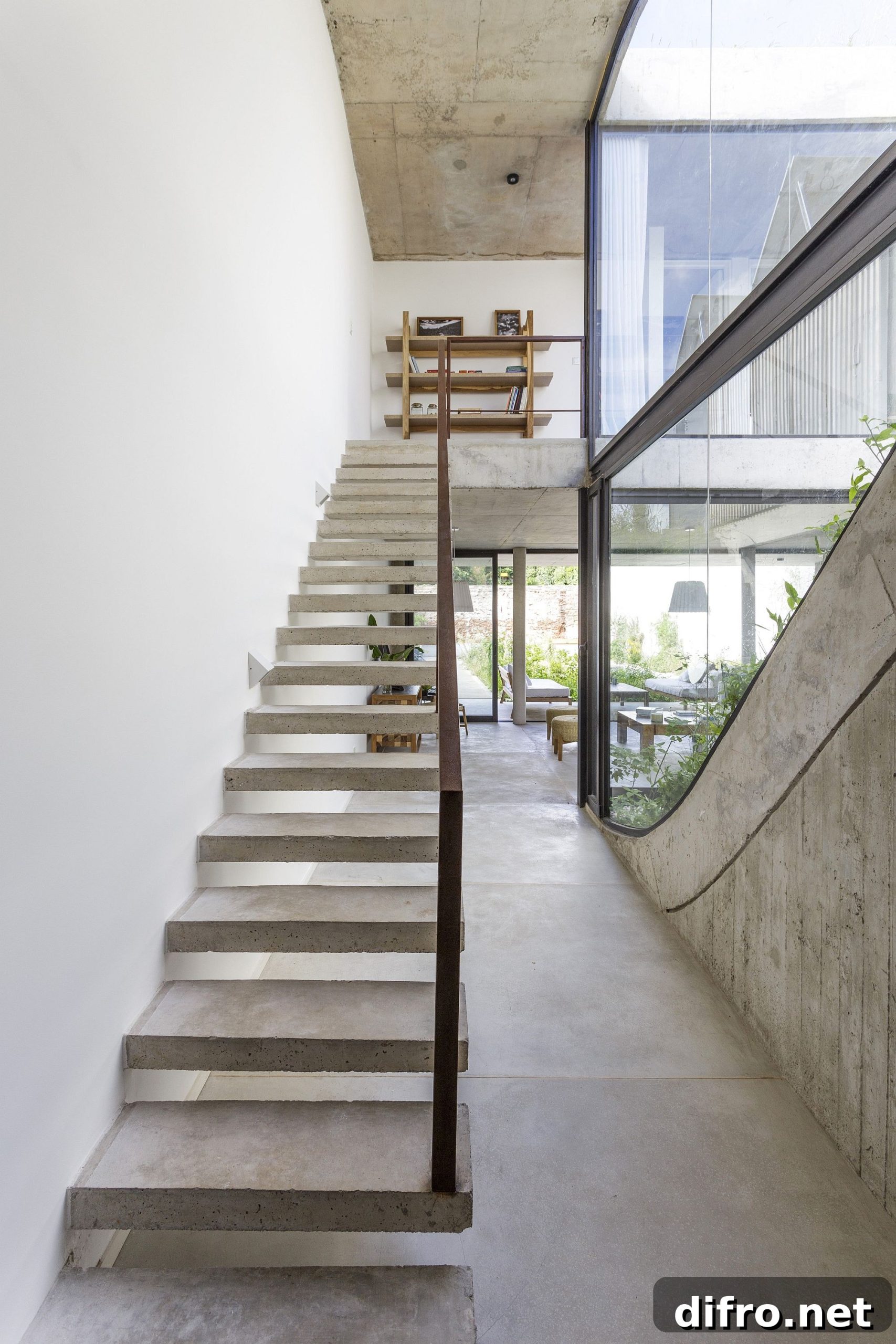 Concrete staircase with steel railing leads to the top level
