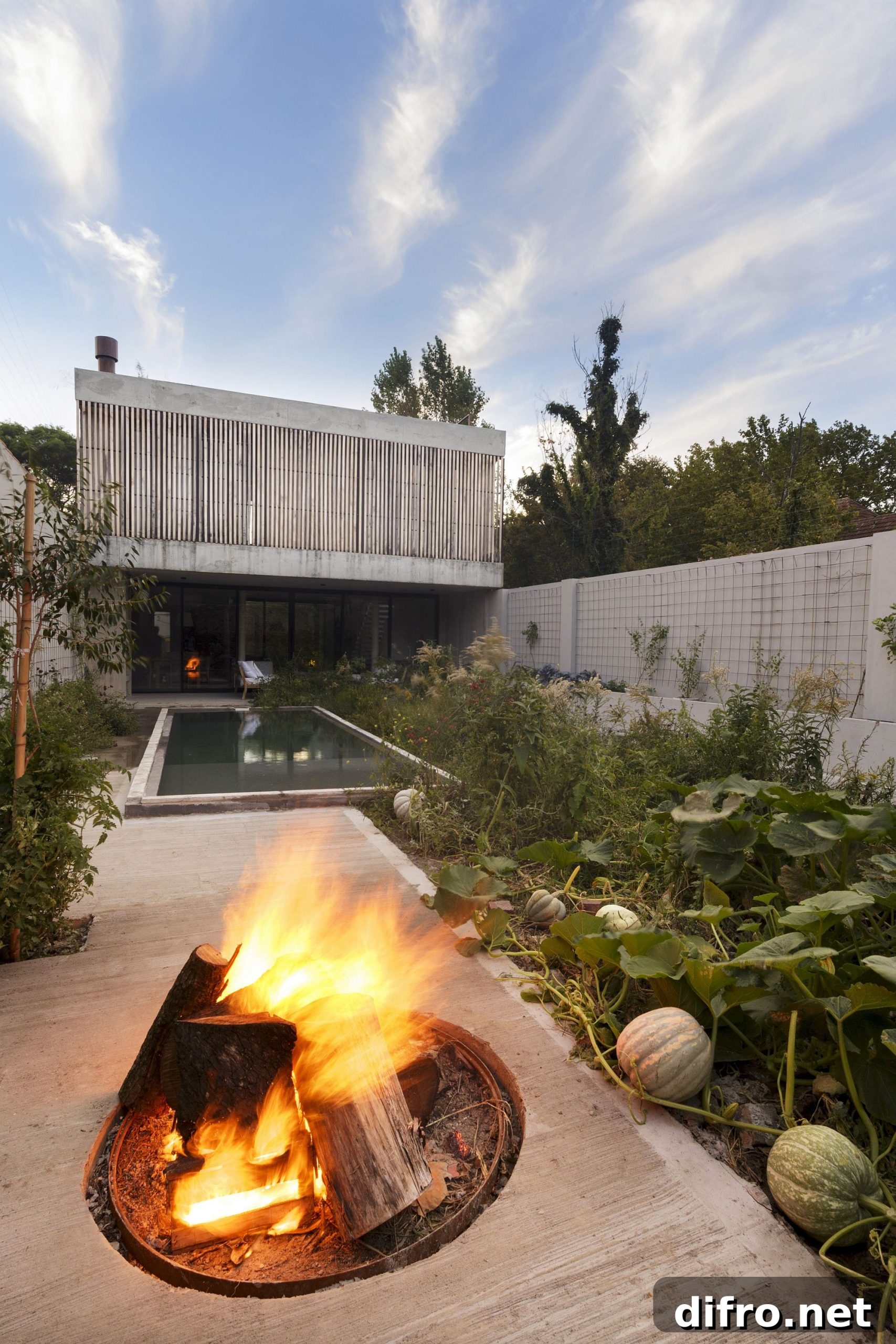 Rear garden, pool and deck with a firepit