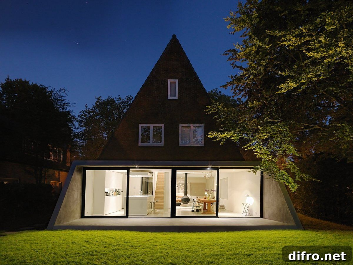 Sliding glass doors and floor-to-ceiling windows connecting the living area with the garden
