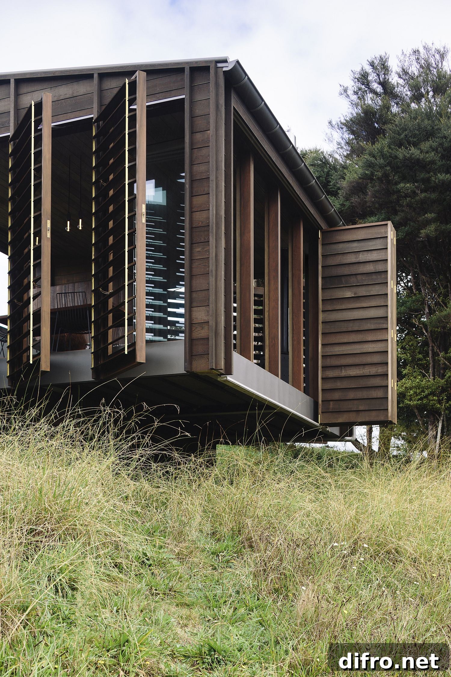 Timber shutters connecting interior and landscape