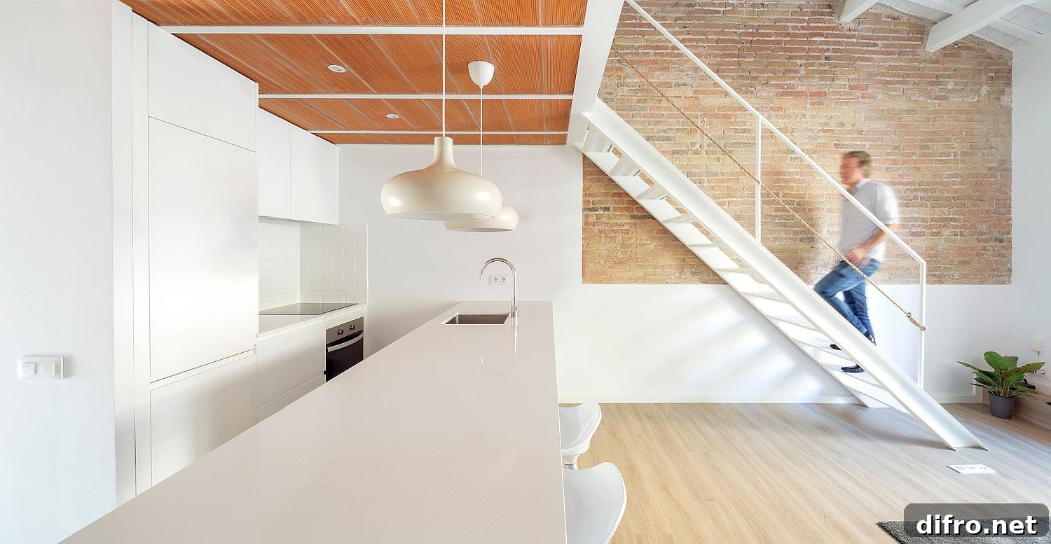All-white kitchen under the mezzanine level with wooden ceiling above