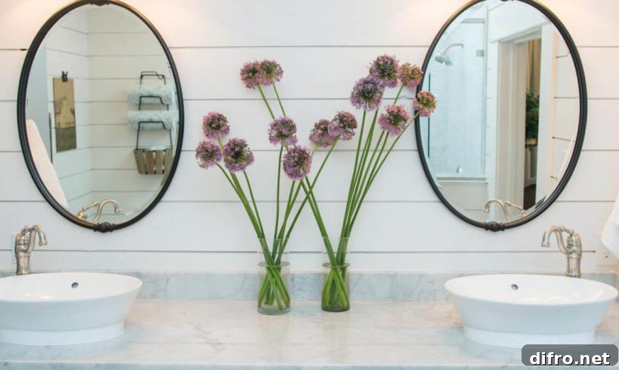 Bathroom with round mirrors and shiplap walls