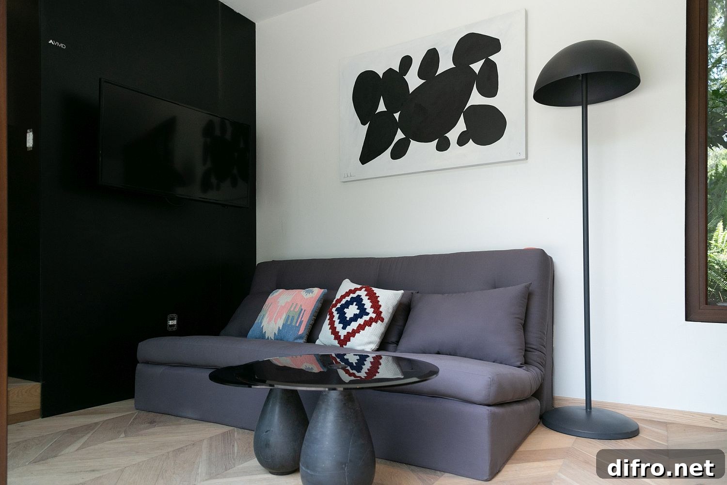 Comfortable gray couch within the compact, eco-conscious interior