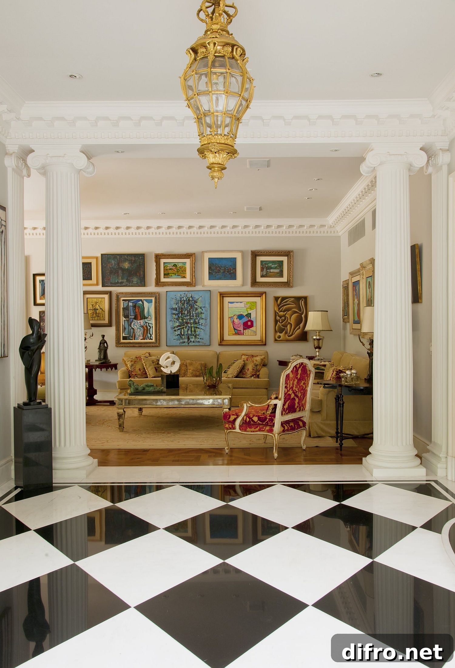 Gallery wall of mixed art pieces creating a classic French-inspired living room look