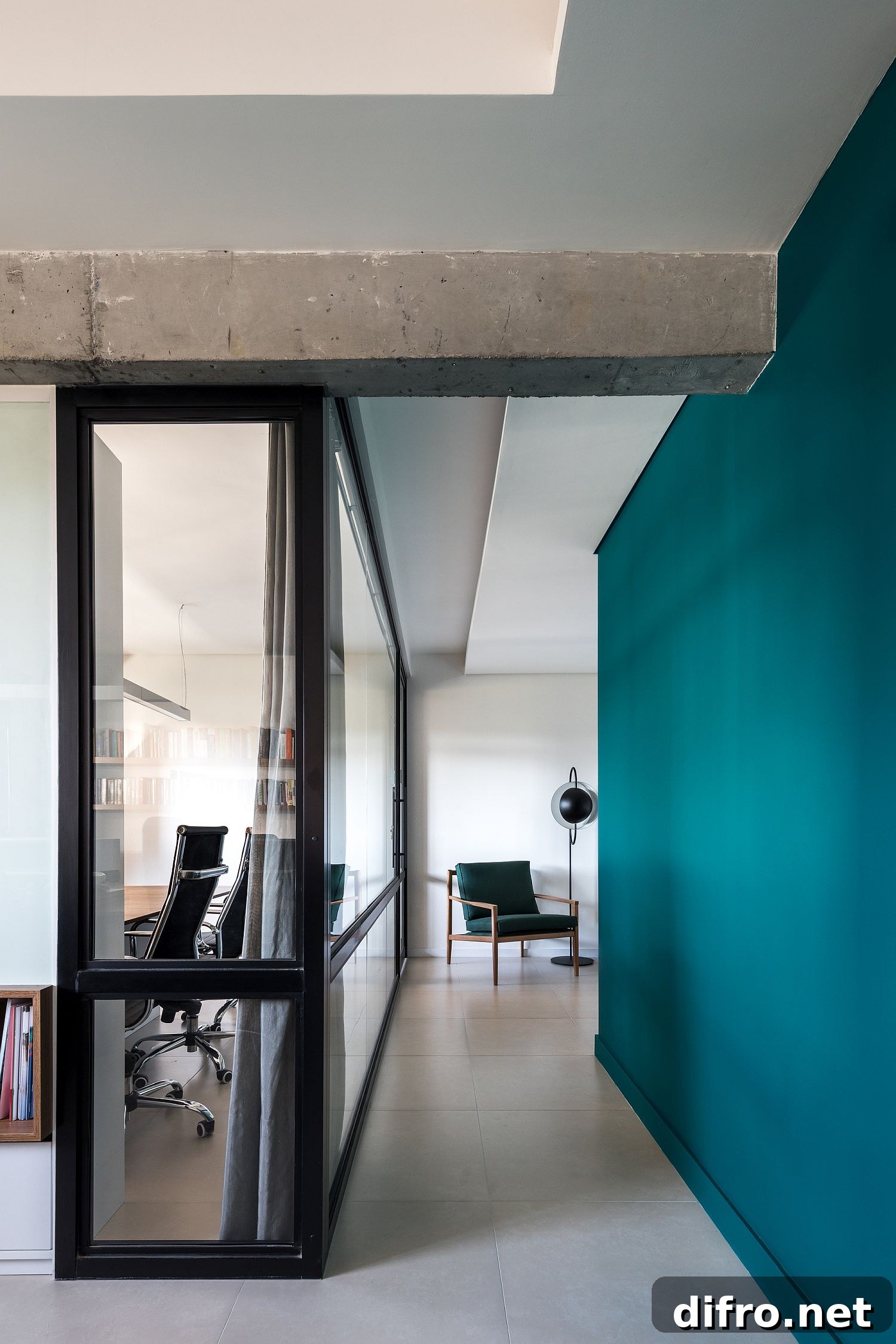 Framed glass walls bring in natural light while the dark green walls hold your attention