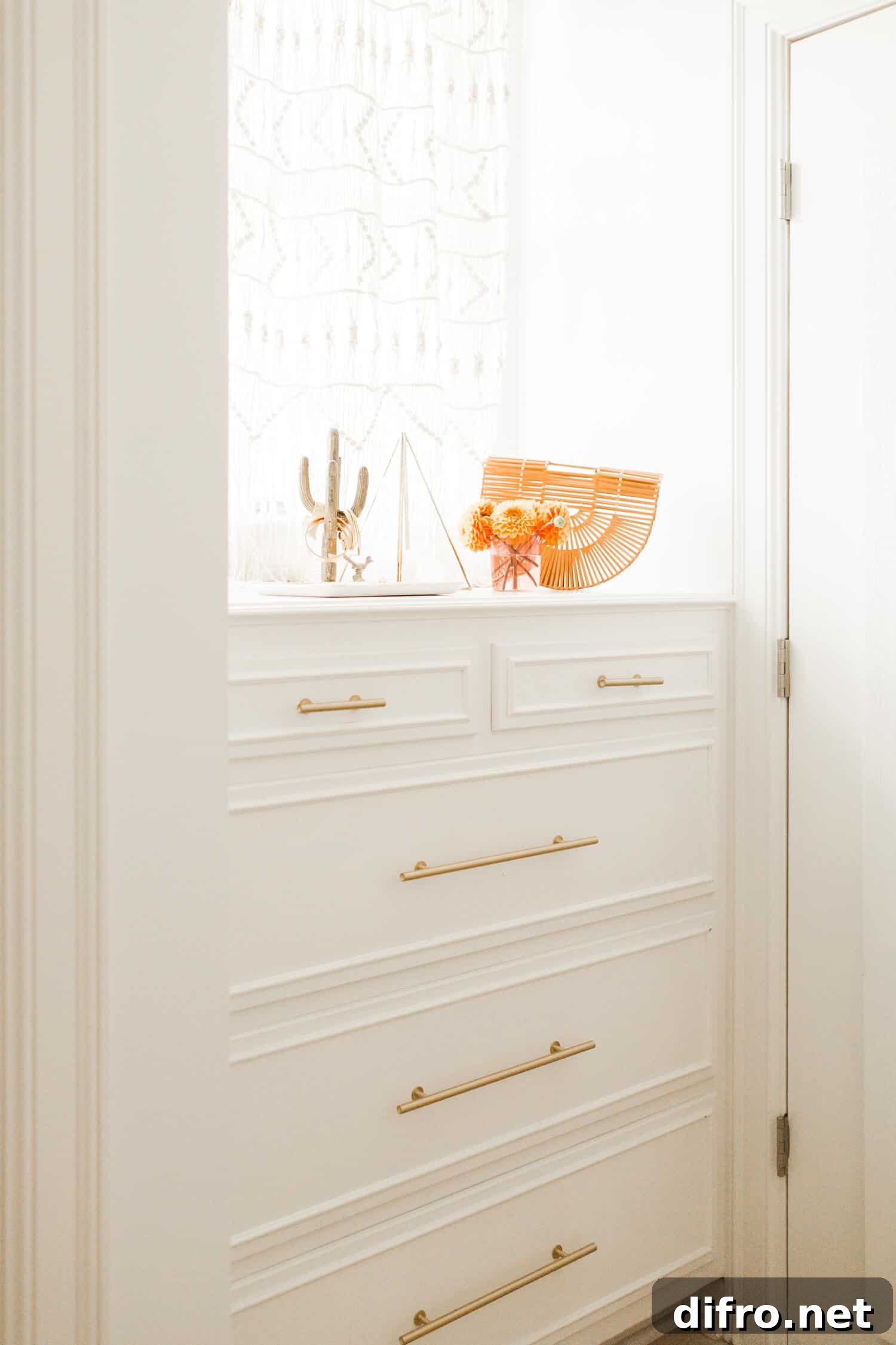 Closet with gold hardware and macrame curtain