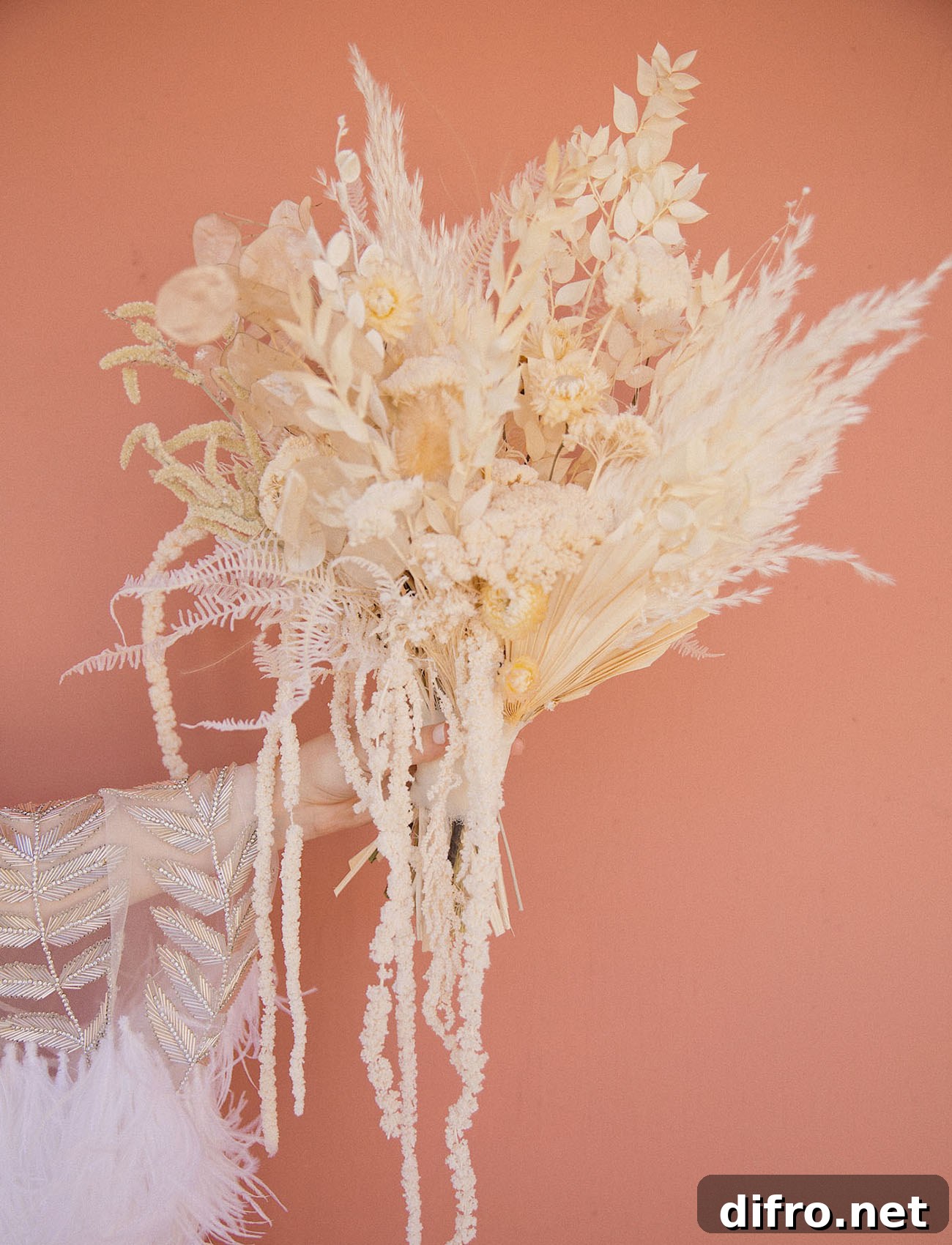 Pampas grass bouquet against blush backdrop