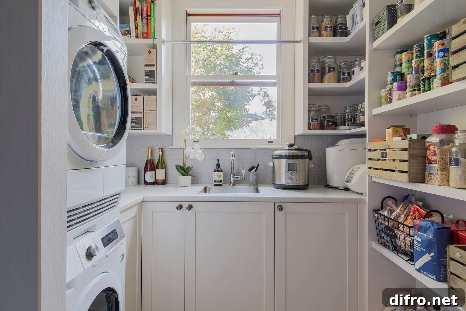 stacked washer dryer in kitchen nook across from pantry