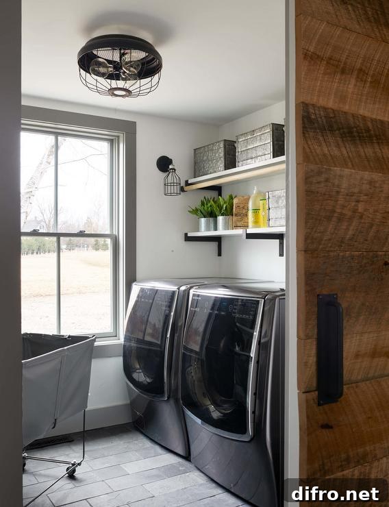 black stainless steel washer and dryer set wood sliding barn door industrial style wall mounted shelves flush mount cage light large window