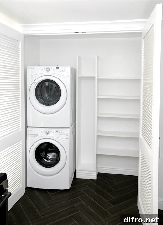 white built in shelves in closet laundry room empty washer and dryer stacked