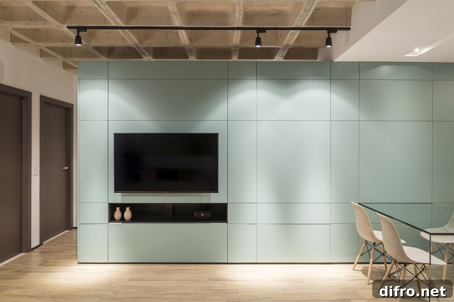 Turquoise multifunctional cabinet highlighted by track lighting
