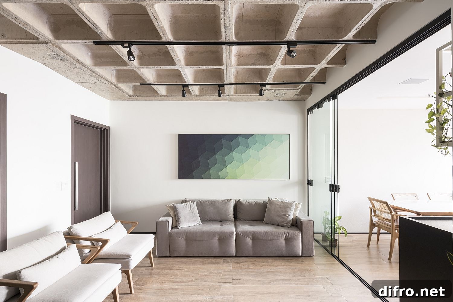Colorful wall art brings contrast to white and concrete living area
