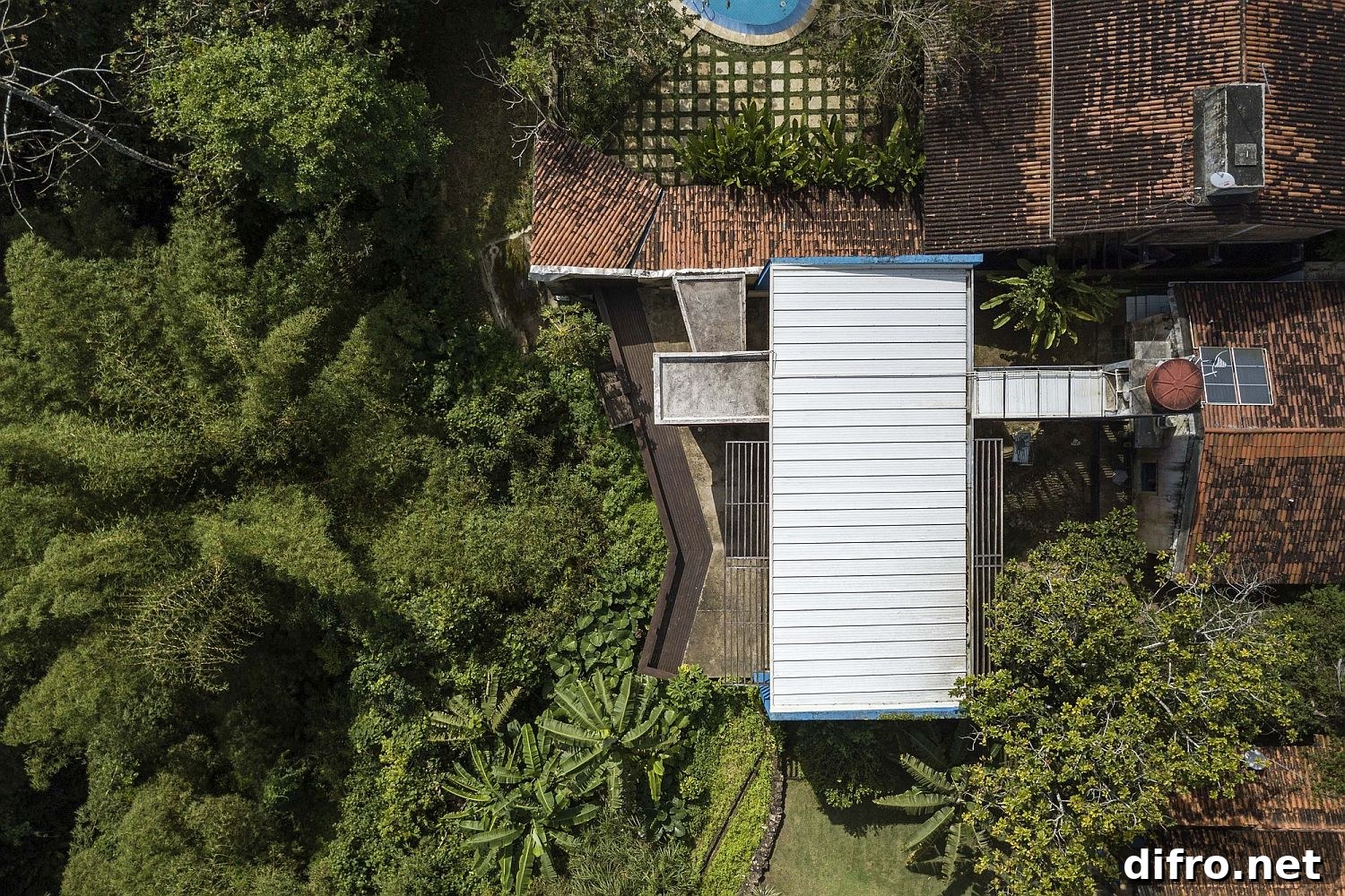 Aerial view of extended house surrounded by jungle